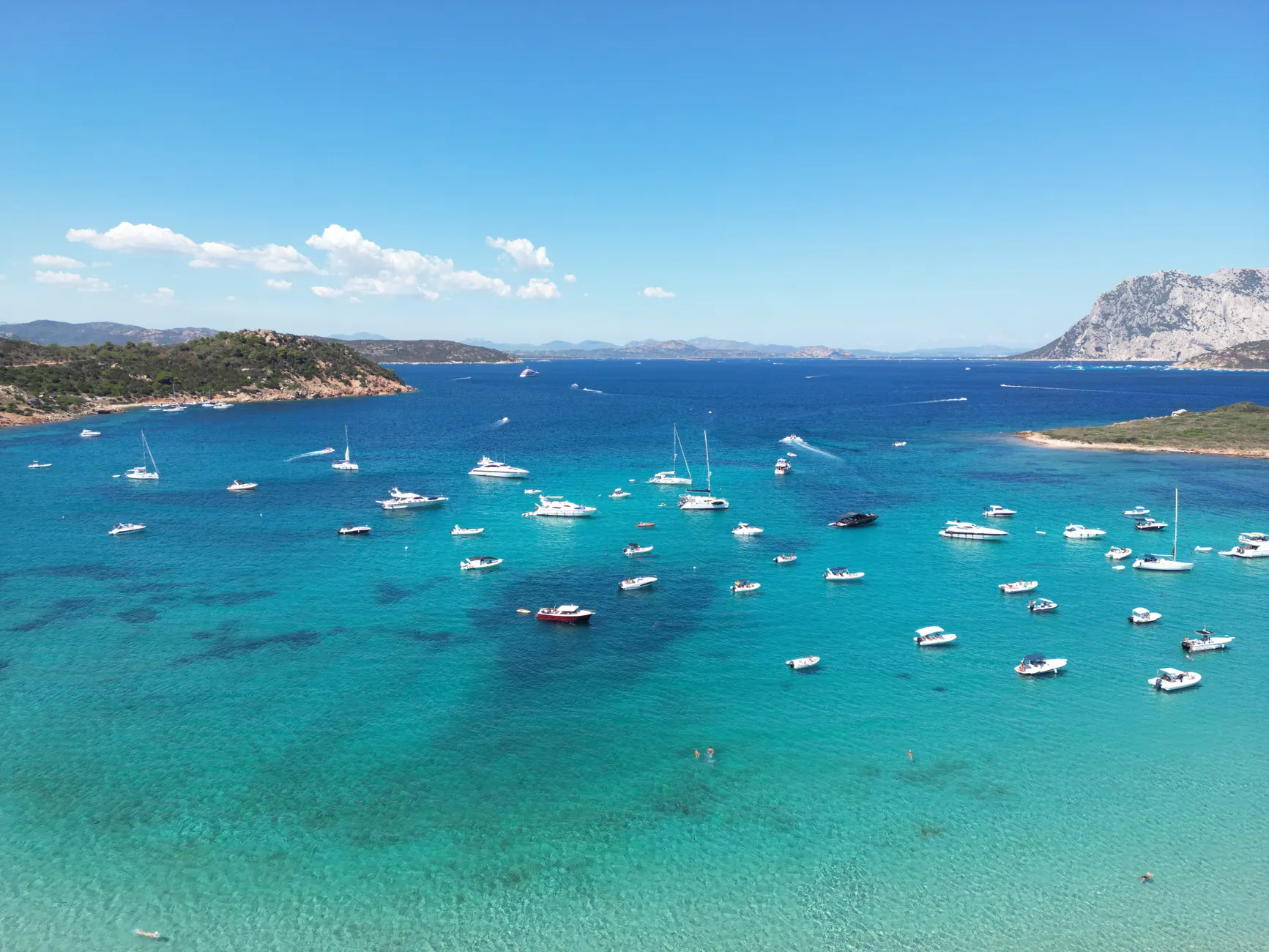 Stunning aerial view of boats on the clear waters of San Teodoro, Sardinia.