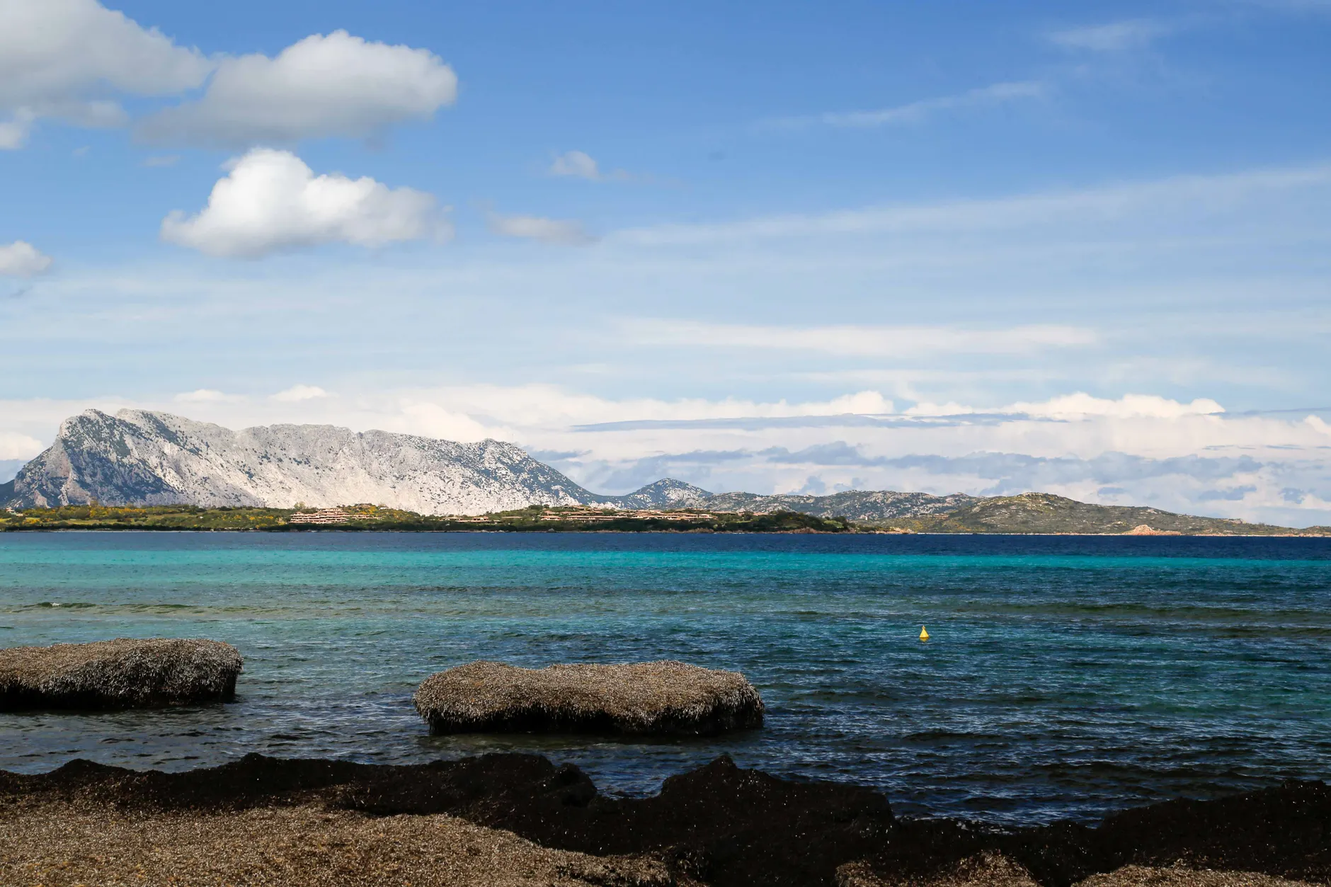 Stunning view of San Teodoro beach with turquoise waters and mountainous backdrop.
